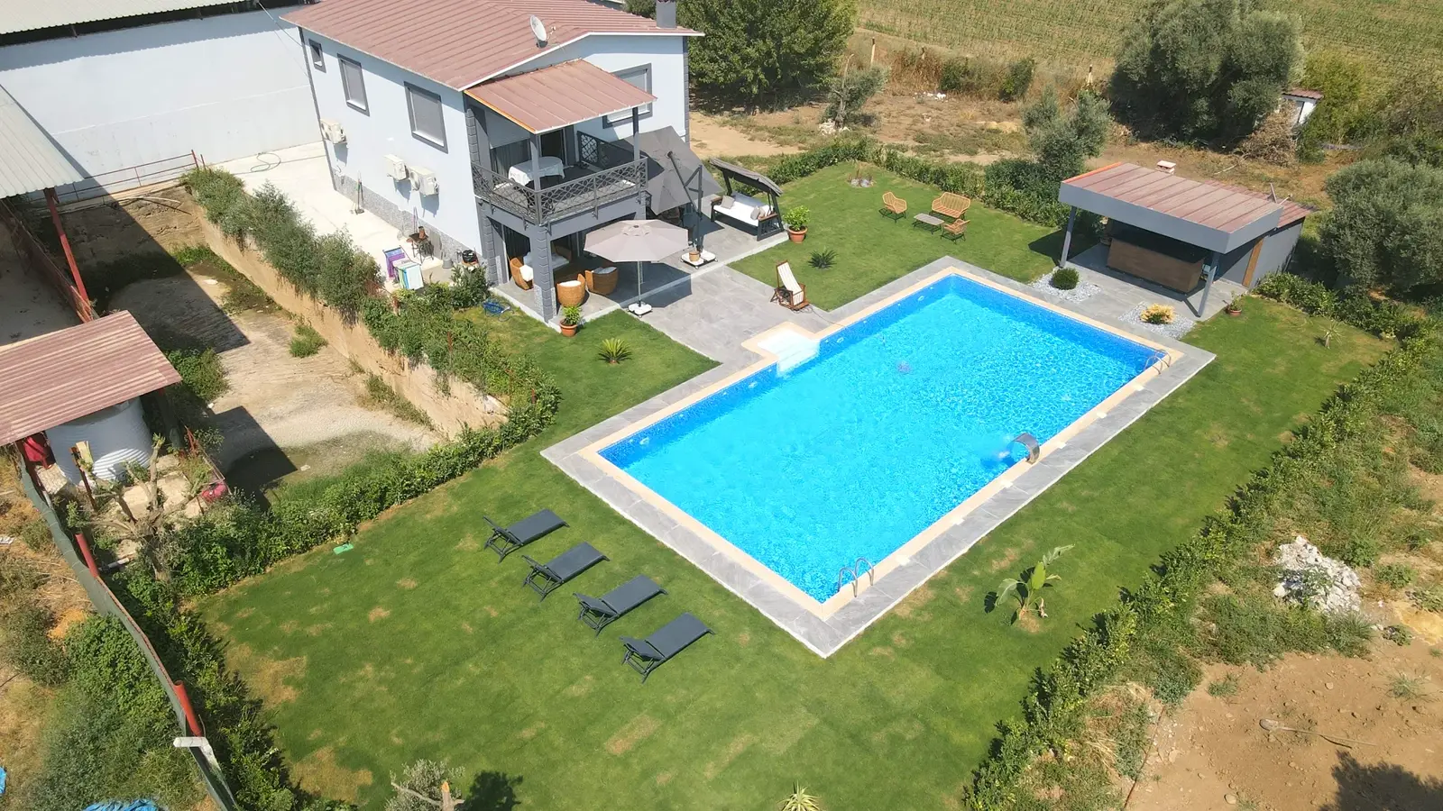 Villa bahçesinde tamamlanmış dikdörtgen havuz, kuşbakışı görünüm