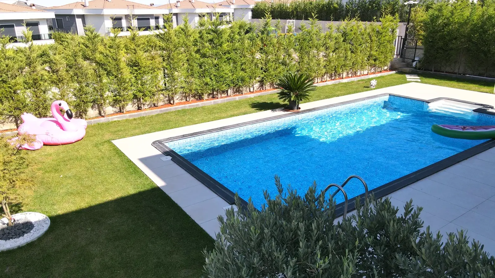 Modern villa bahçesinde havuz ve oturma alanı